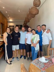 a group of people posing for a picture in a room at POUSADA CHARLOTTE in Tiradentes