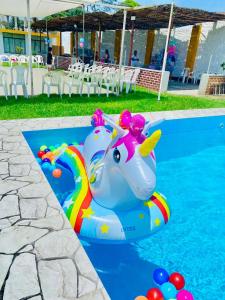 a inflatable elephant in the water next to a pool at Villa Mia - Casa de campo in Moche