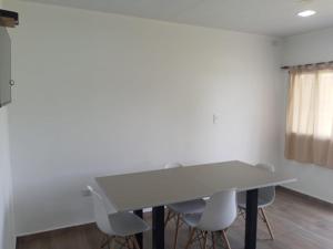 a white table and chairs in a room with a window at Complejo - LA ZULA - 1y2Dormitorios in Federación