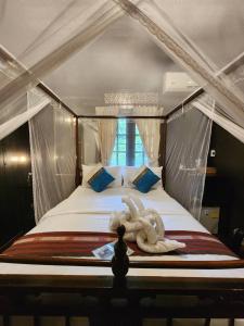 a large bed with an animal laying on top of it at Club One Seven Gaymen Chiang Mai in Chiang Mai