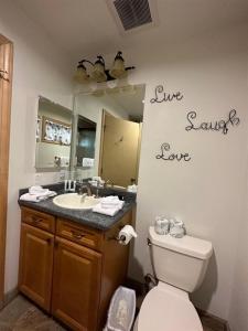 a bathroom with a sink and a toilet and a mirror at Rr-johnson Suite 2 in June Lake