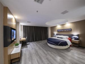 Krevet ili kreveti u jedinici u objektu Lano Hotel Jiangxi Nanchang Olympic Sports Center of High-tech Zone