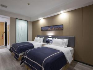 מיטה או מיטות בחדר ב-Lano Hotel Jiangxi Nanchang Olympic Sports Center of High-tech Zone