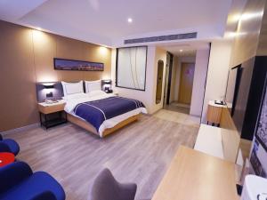 a hotel room with a large bed and a desk at Lano Hotel Guizhou Zunyi Renhuai Power Supply Bureau Office Building in Zunyi