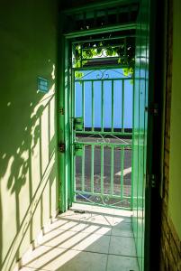 a green door with a gate in a building at La Casa de Adry in Cali