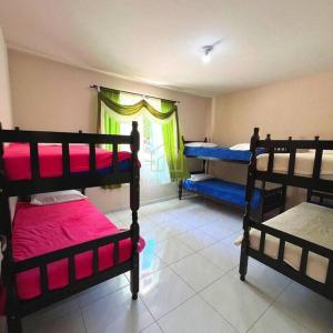 Cette chambre comprend 3 lits superposés et une fenêtre. dans l'établissement Sítio Ribeirão Bonito, à Pinheiral