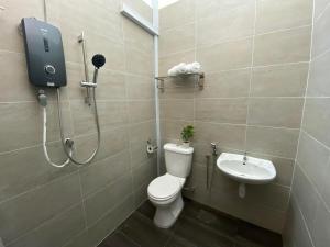 a bathroom with a shower and a toilet and a sink at LYL HOMESTAY-IPOH 10Pax 4R in Ipoh +10 photos