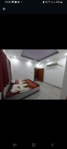 a room with a bed in the middle of it at VTP Guest House in Bikaner