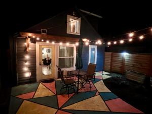 a patio with a table and chairs and lights at Private NE Portland Guesthouse in Portland