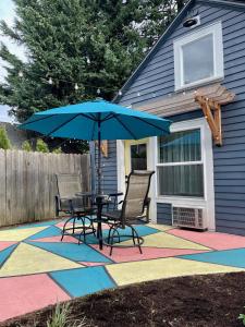 a patio with a table and chairs and an umbrella at Private NE Portland Guesthouse in Portland
