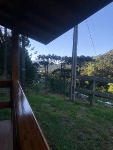 a view from a window of a field with a fence at Cabanas do Empório Aparados da Serra in Bom Jardim da Serra