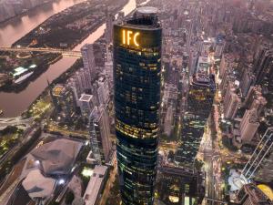 a lit up skyscraper with the hr sign on it at Four Seasons Hotel Guangzhou in Guangzhou