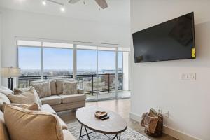 a living room with a couch and a flat screen tv at Dallas Dreamscape in Dallas