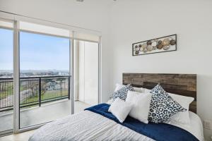 a bedroom with a bed and a large window at Dallas Dreamscape in Dallas
