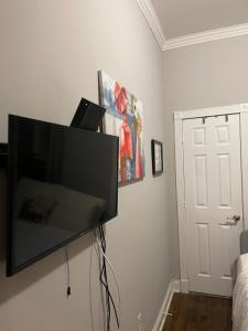a flat screen tv hanging on a wall at Private one bedroom one bathroom in New York