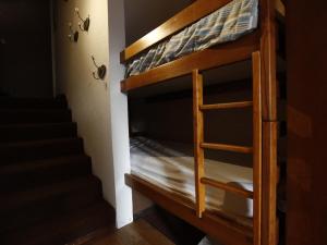 a bunk bed with a ladder in a room at Appartement Avoriaz, 2 pièces, 4 personnes - FR-1-314-269 in Morzine