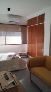 a living room with a bed and a couch at Quilmes departamentos in Quilmes