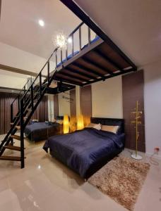 a bedroom with a large bed and a staircase at Green Home Pool Villa Hua Hin in Ban Wang Bot