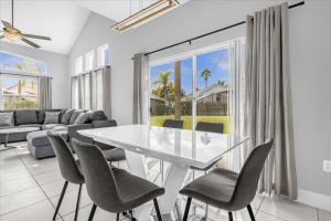 a dining room with a white table and chairs at 4 Bedrooms 35 Bathrooms Lake Berkley 938 Pt in Kissimmee