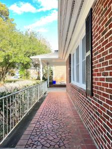 a brick walkway next to a building with a window at Ranch House North Decatur 5 mins to Emory University in Decatur