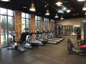 a gym with a row of treadms and machines at 3 Bedrooms- 2,5 Bathrooms- Festival 1880 Sa in Davenport