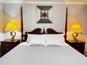 a bedroom with a bed with two lamps on it at Ranch House North Decatur 5 mins to Emory University in Decatur