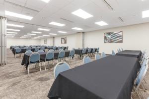 a conference room with tables and chairs in it at Comfort Inn & Suites in Beaver Dam