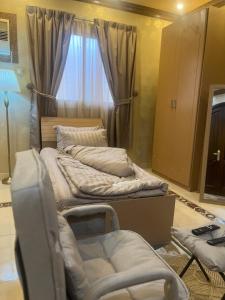 a room with three beds and a window at دار هند شقق مفروشة بحي سكني in Al Madinah