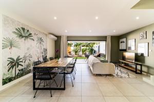 een eetkamer met een tafel en stoelen bij Villa moderne Manapany -Jacuzzi-Proximité mer in Saint-Joseph