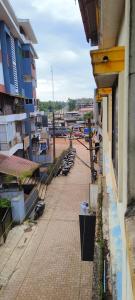 a balcony of a building with benches on a sidewalk at Prakruthi home stay in Mangalore