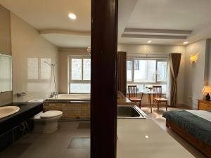 a bathroom with a sink and a toilet and a tub at NEW LAND Apartment 2 - Phu My Hung in Ho Chi Minh City