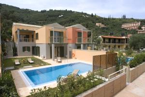 a view of a house with a swimming pool at Erkina Villas Kalami Corfu in Kalami