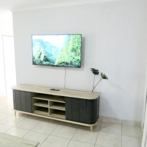 a living room with a tv on a wall at 43 Home self Catering with backup power in eMalahleni