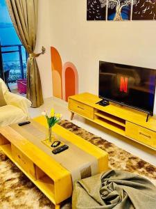 a living room with a couch and a television at SeasideSerenity#Forest City in Gelang Patah