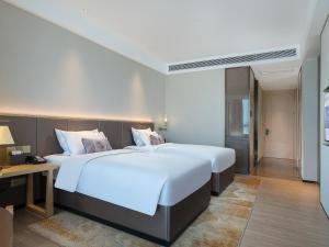 Letto o letti in una camera di Echeng Hotel - Huawei Base Store in Shenzhen