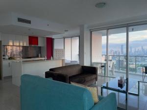 a living room with a couch and a table at Skyline and Mountain View CBD Stay in Gold Coast