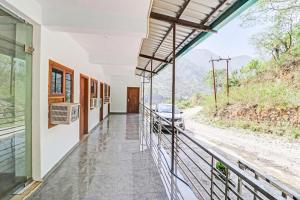 a house on a hill with a view of a road at Super Collection O Hotel Studioz Om River Resort in Rājpur