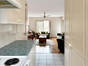 a kitchen and living room with a living room at Northward Unit 1 1 2 Magnus St Nelson Bay in Nelson Bay
