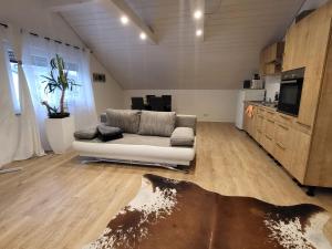 a living room with a couch and a kitchen at Stern Apartment in Wehr