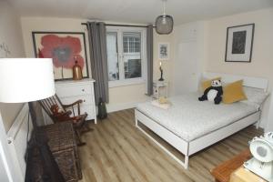 a bedroom with a bed with a panda bear on it at COSY CAMDEN 2 BEDROOM APARTMENT WITH TERRACE in London