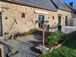 a bird house in front of a brick building at la hamonniere in Savigny-le-Vieux