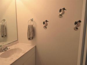 a bathroom with a sink and a mirror and towels at Immaculate 2Nd Floor Duplex In Brant Beach Located Just 3 Homes From The Beach in Brant Beach +8 photos