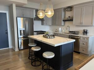 a kitchen with a large island with bar stools at Tastefully Decorated Condo in Ship Bottom