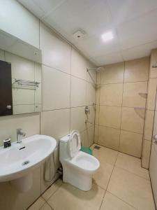 a bathroom with a sink and a toilet and a mirror at HOTEL LETS STAY in Ernakulam