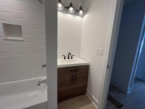 a bathroom with a sink and a bath tub at Agresti Mil in Brant Beach