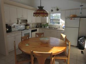 a kitchen with a wooden table with a bowl on it at Lagoon Front Home In Harvey Cedars in Harvey Cedars