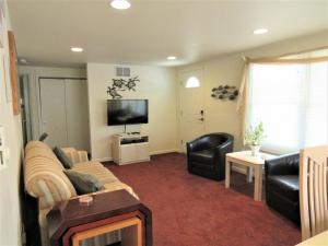 een woonkamer met een bank en een flatscreen-tv bij 1st Floor Duplex In Brant Beach Just 3 Homes From The Beach in Brant Beach