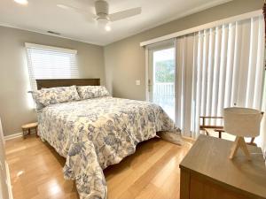 a bedroom with a bed and a large window at Family Friendly Vacation Rental On Lbi in Beach Haven