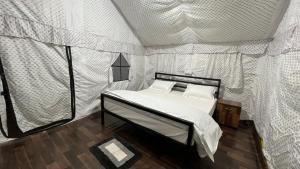 a bedroom with a bed in a tent at Sari Highlands in Sari