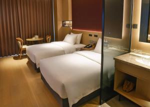 Katil atau katil-katil dalam bilik di Maison New Century Tongxiang